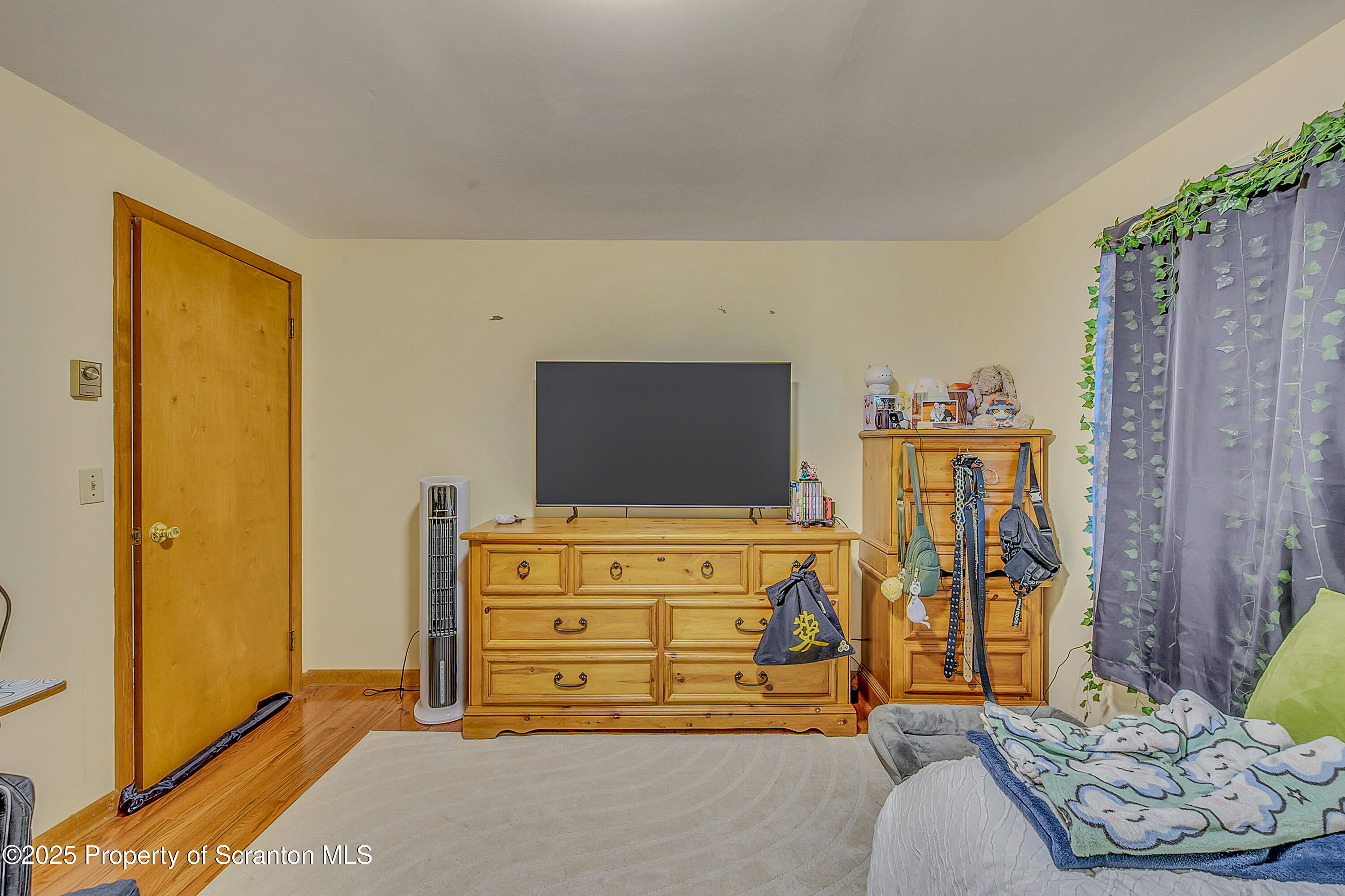 1002 Pheasant Run Road Clarks Summit, PA 18411 - Photo 36 of 53 a bedroom with a bed and flat screen tv