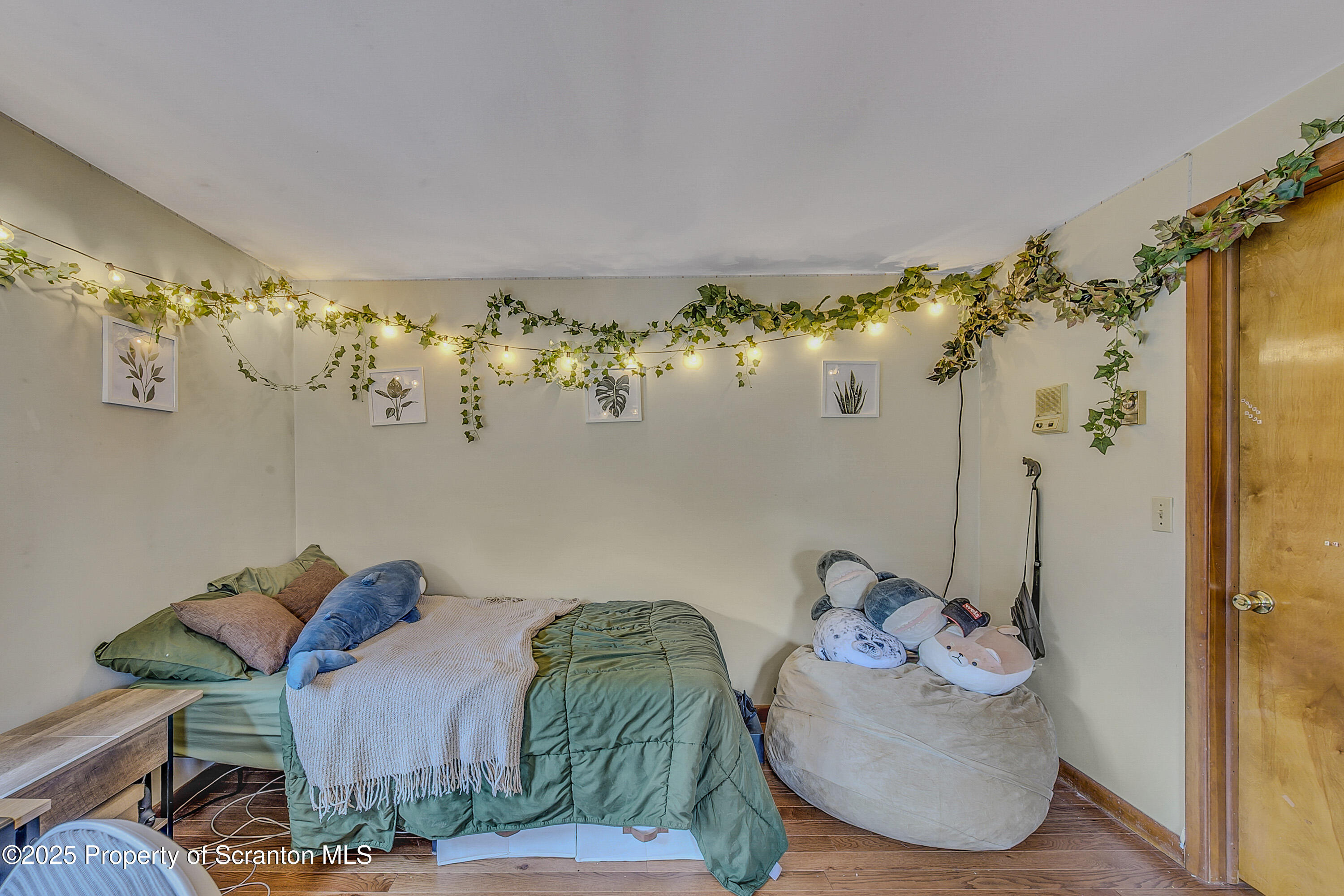 1002 Pheasant Run Road Clarks Summit, PA 18411 - Photo 42 of 53 a view of a bedroom with furniture and chandelier