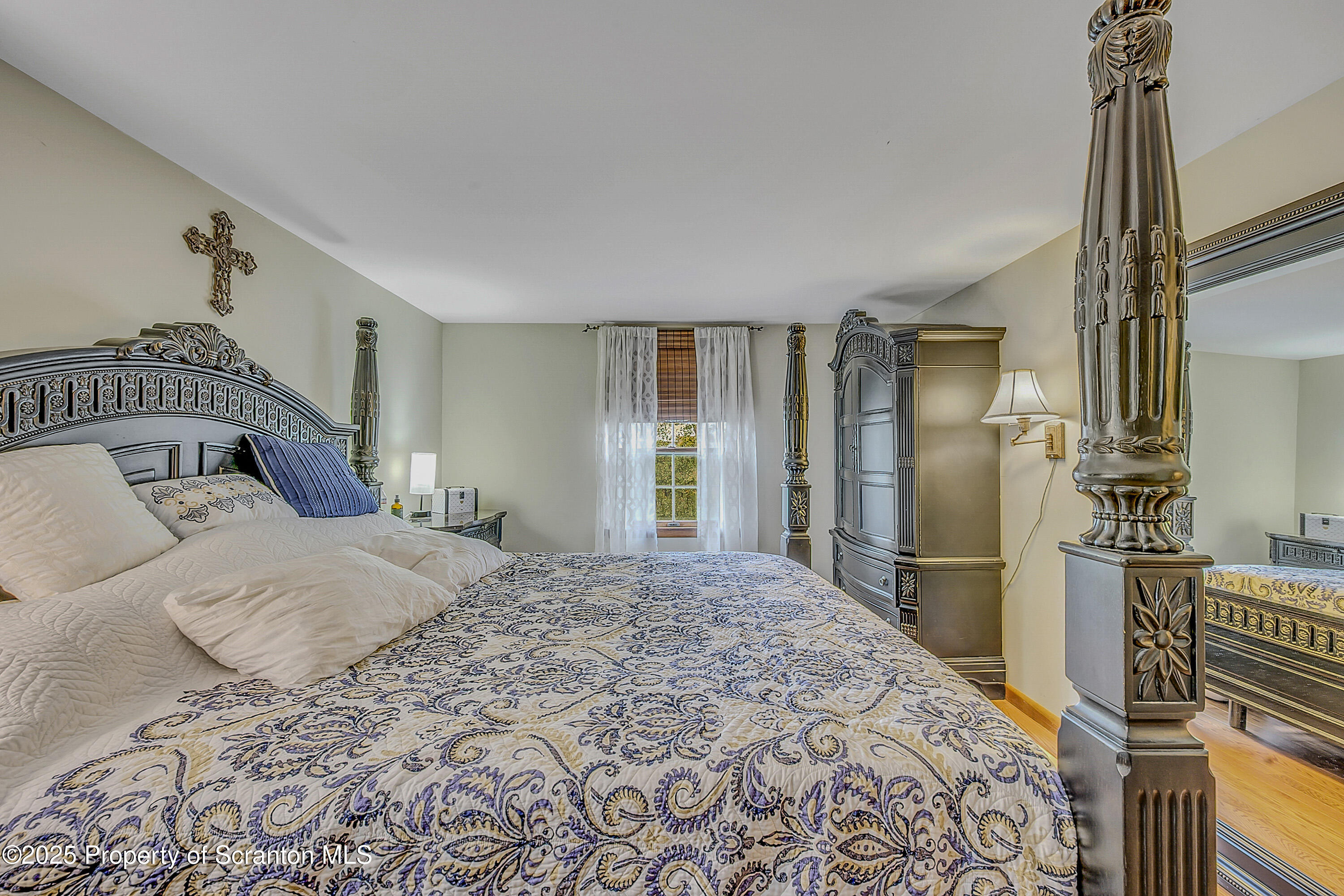 1002 Pheasant Run Road Clarks Summit, PA 18411 - Photo 49 of 53 a bedroom with a bed and dresser with mirror