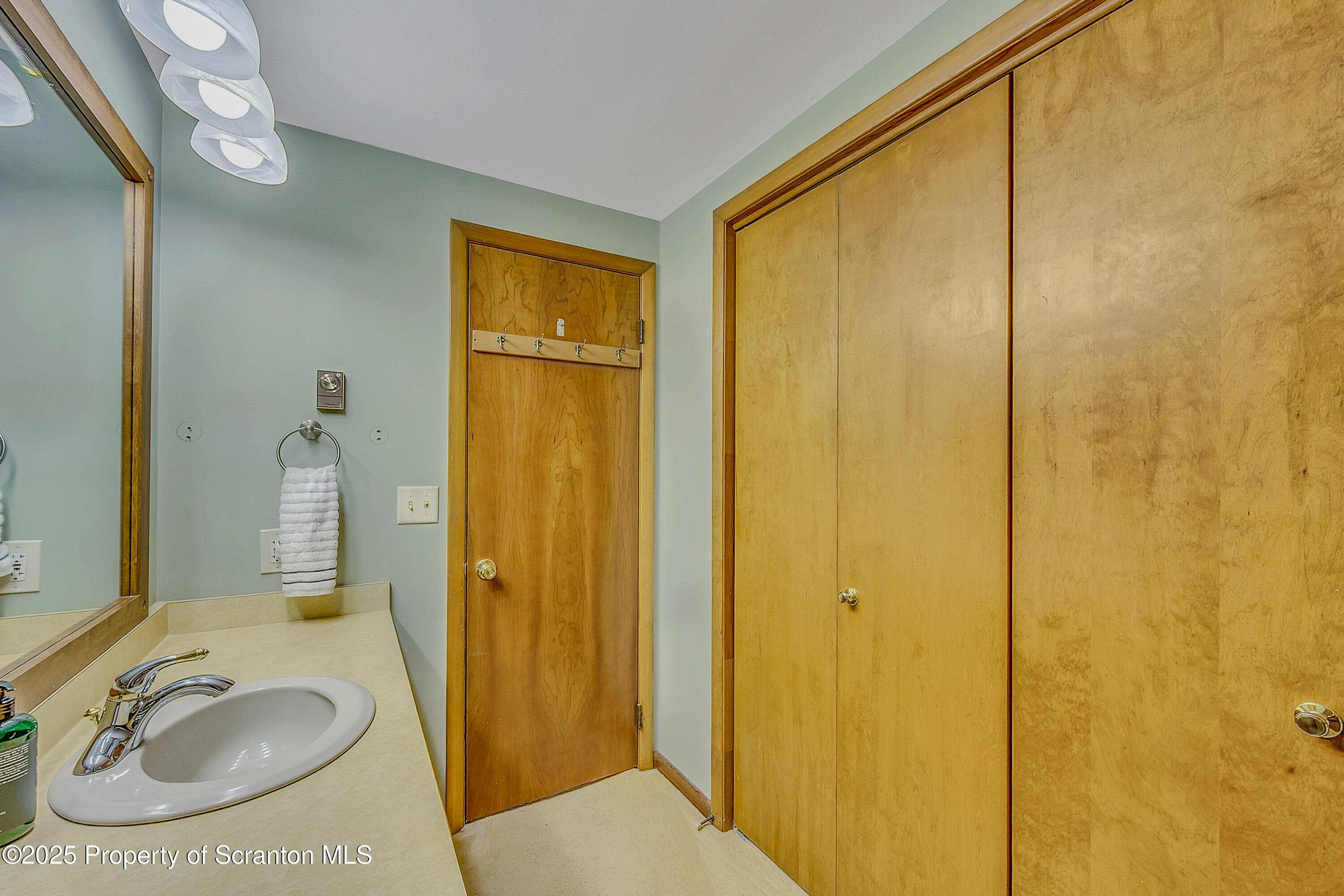 1002 Pheasant Run Road Clarks Summit, PA 18411 - Photo 52 of 53 a bathroom with a sink a mirror and a shower