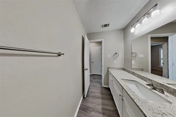 a bathroom with a double vanity sink and mirror