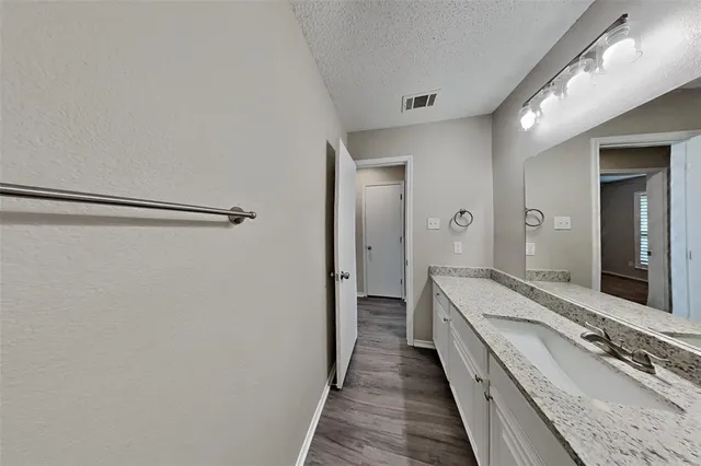 a bathroom with a double vanity sink and mirror