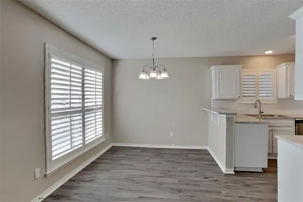 a view of a kitchen with a sink dishwasher and fireplace