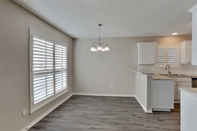 a view of a kitchen with a sink dishwasher and fireplace