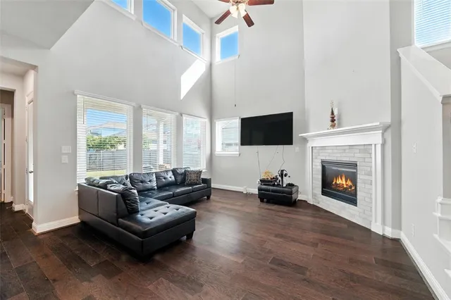 a living room with furniture a fireplace and a flat screen tv