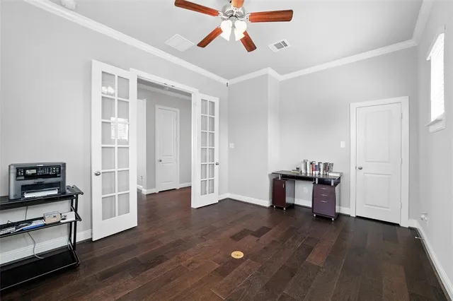 a view of a workspace with furniture wooden floor and a ceiling fan