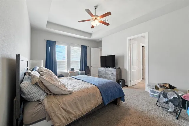 a bedroom with bed and a tv