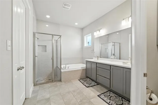a bathroom with a double vanity sink toilet and shower