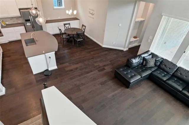 a living room with furniture and a wooden floor