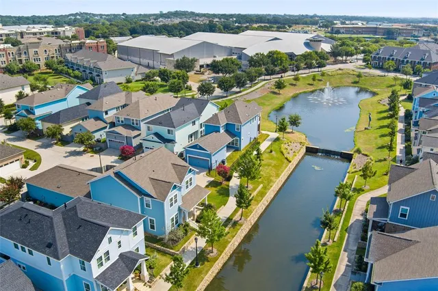 an aerial view of residential houses with outdoor space and river view