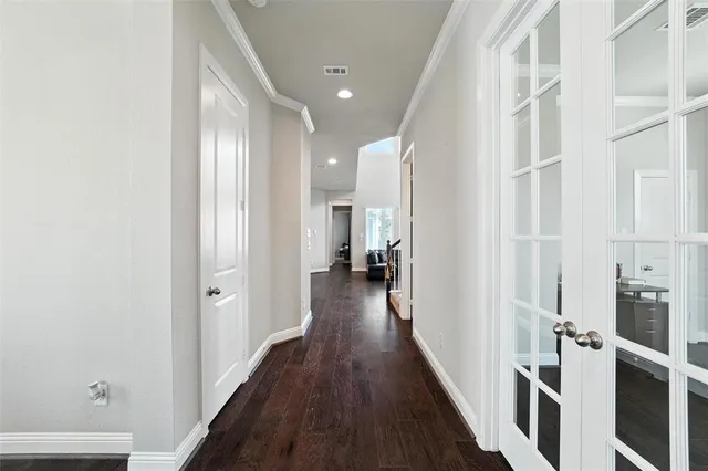 a view of hallway with wooden floor