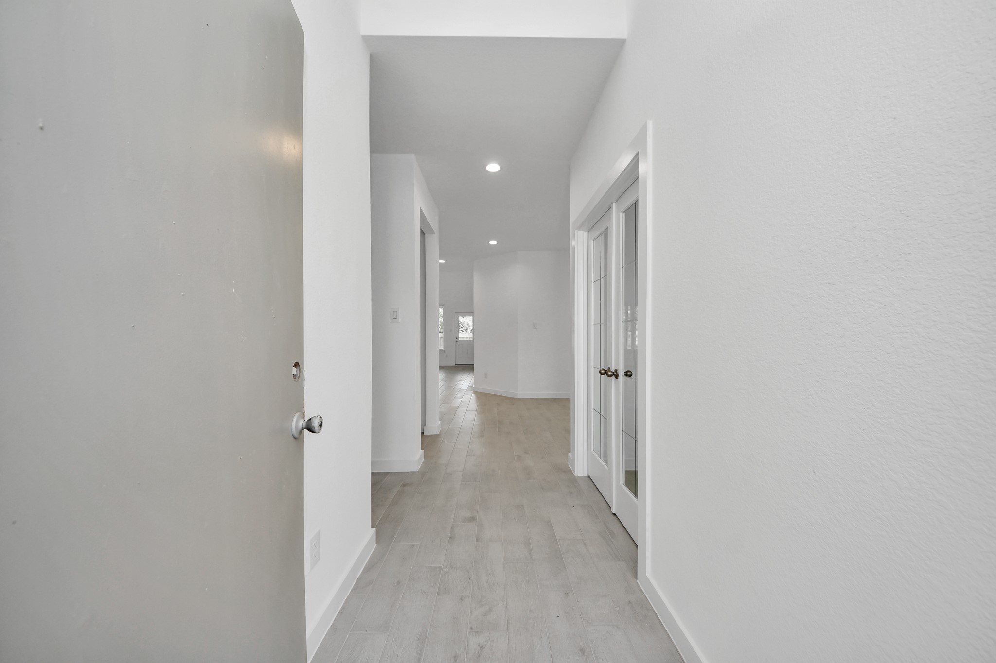 2926 Bury Park Dr Spring Spring, TX 77373 - Photo 6 of 40 As you step into the threshold of this luxurious home, you'll soon be welcomed by an elegant glass door (to be installed). Inside, soaring ceilings amplify the spaciousness, while the refined wood-look tile flooring and oversized baseboards exude sophistication and charm.