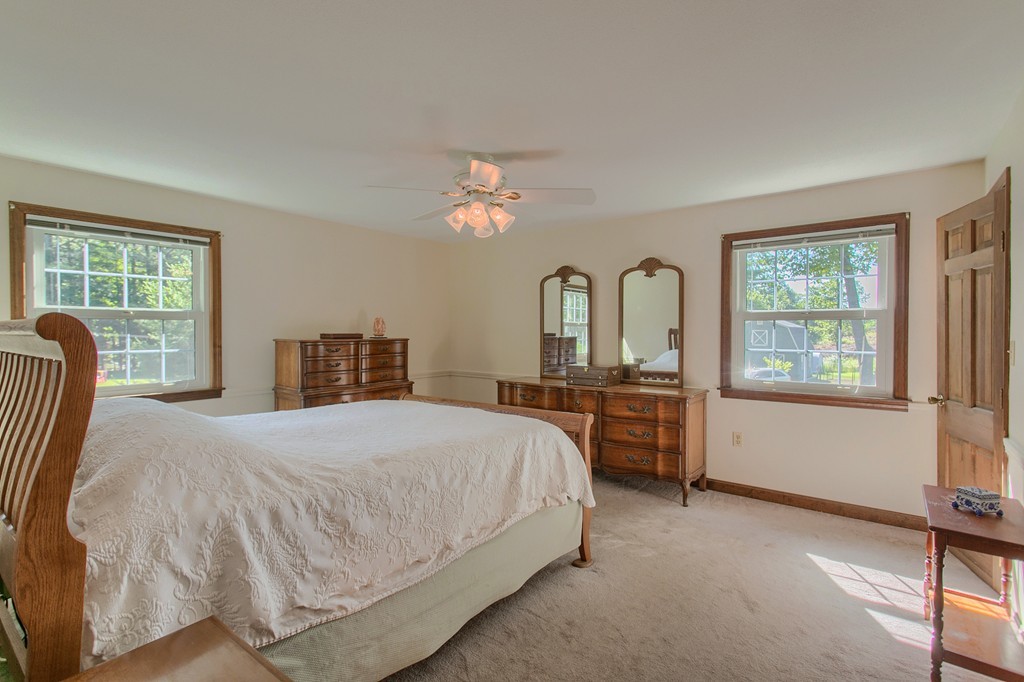 24 Newton Road Westminster, MA 01473 - Photo 21 of 30 a bedroom with a large bed and a chandelier