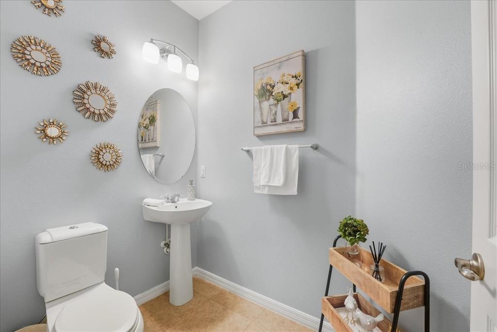 11675 Snail Kite Way Windermere, FL 34786 - Photo 17 of 46 a bathroom with a toilet sink and mirror