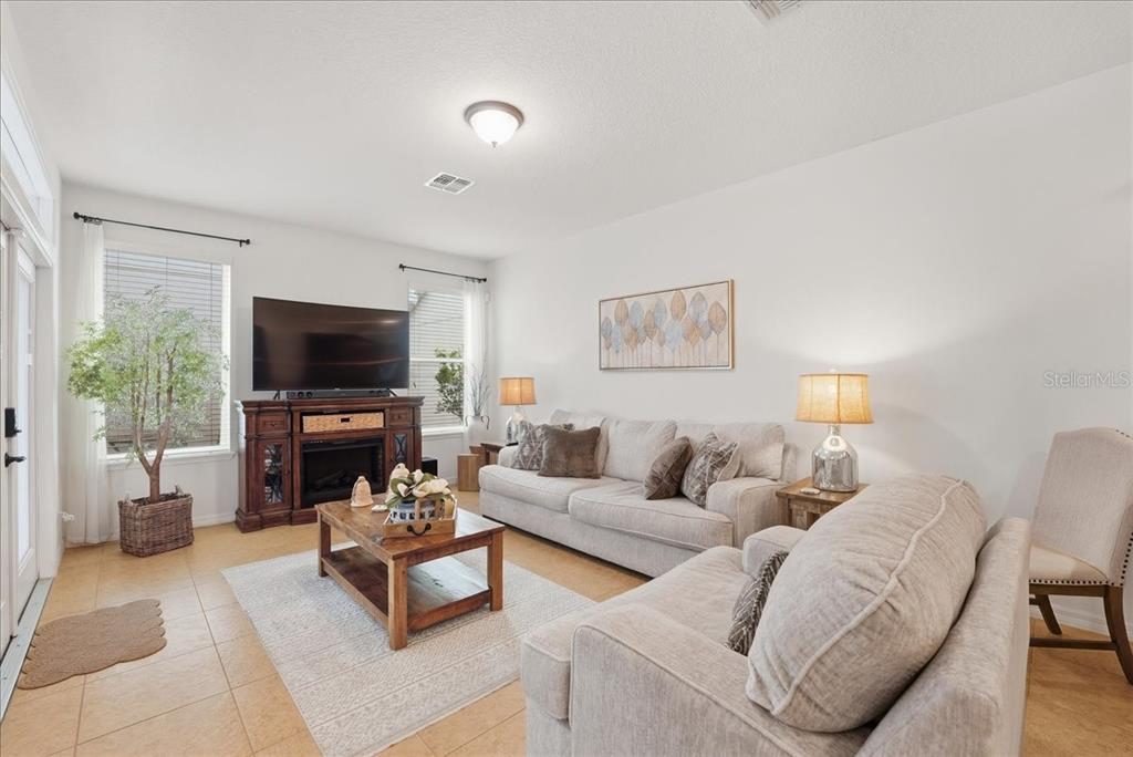 11675 Snail Kite Way Windermere, FL 34786 - Photo 20 of 46 a living room with furniture and a flat screen tv