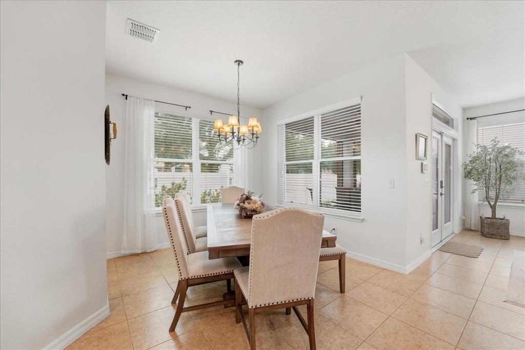 11675 Snail Kite Way Windermere, FL 34786 - Photo 21 of 46 a view of a dining room with furniture window and outside view