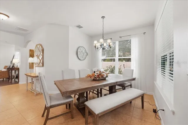 a view of a dining room with furniture and chandelier