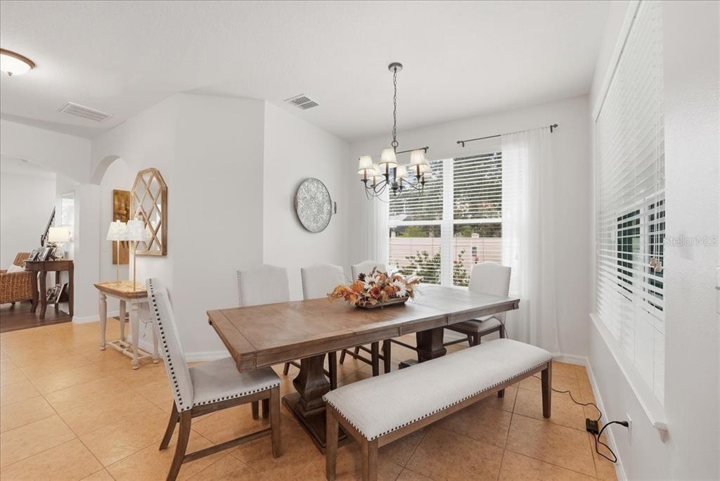 11675 Snail Kite Way Windermere, FL 34786 - Photo 22 of 46 a view of a dining room with furniture and chandelier