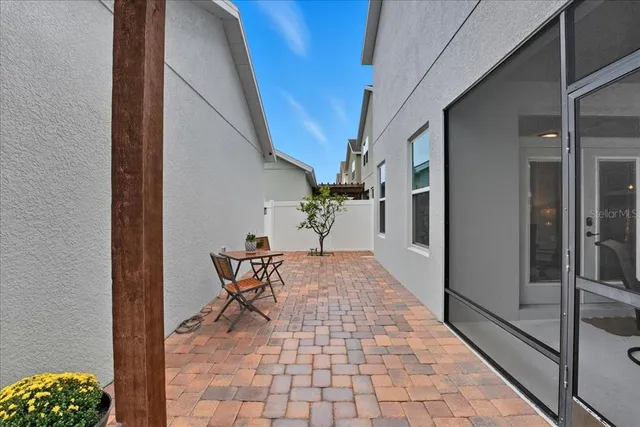a view of a patio with a table and chairs and potted plants