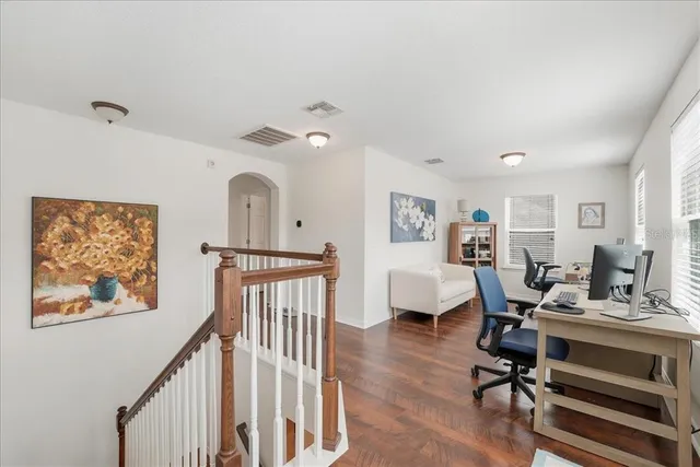 a view of a livingroom with workspace and a window