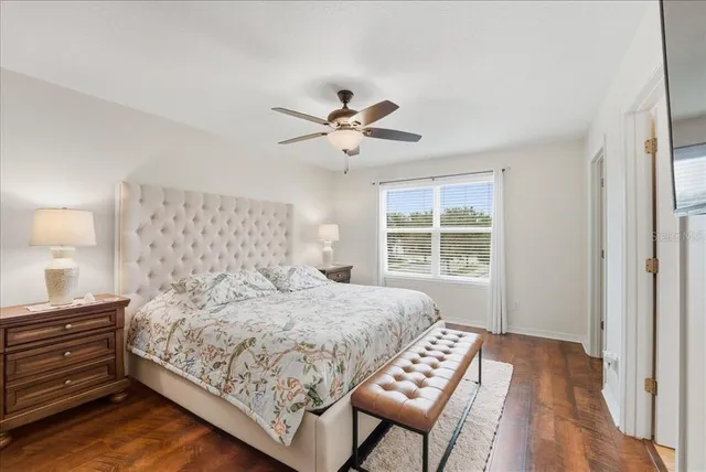 a bedroom with a bed and a chandelier