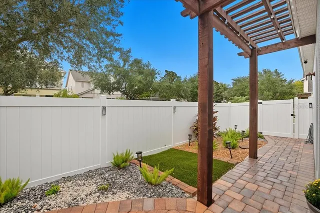 a view of a porch with furniture and a yard
