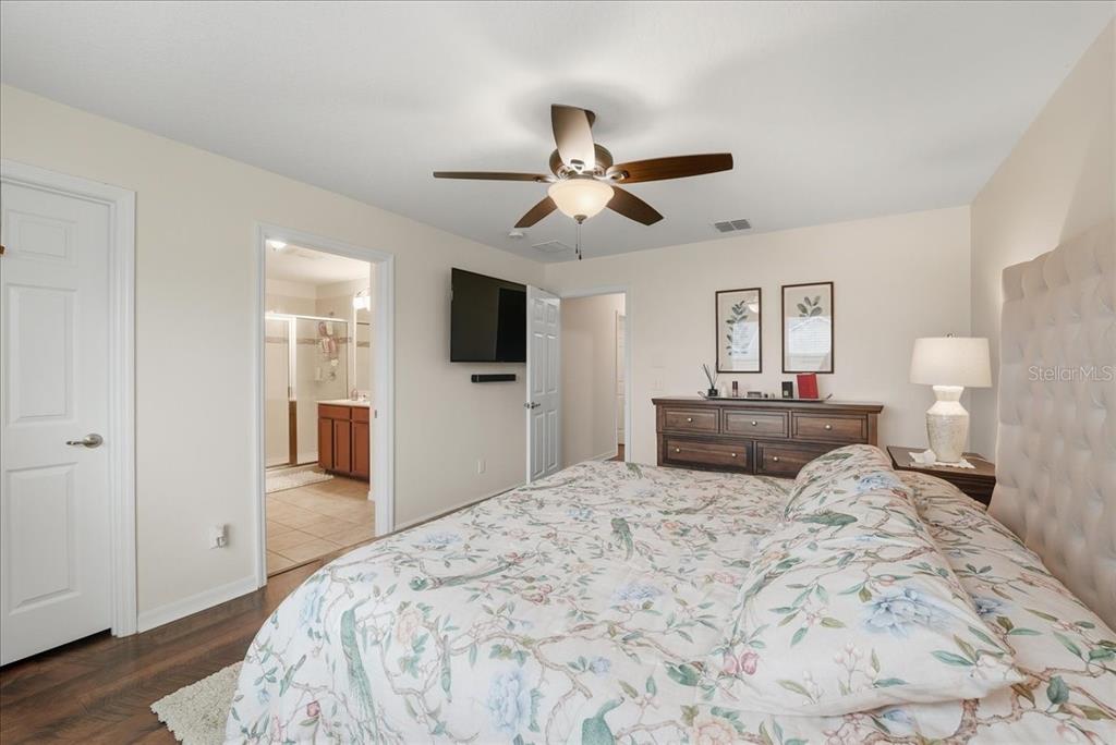 11675 Snail Kite Way Windermere, FL 34786 - Photo 32 of 46 a bedroom with a bed and a flat screen tv