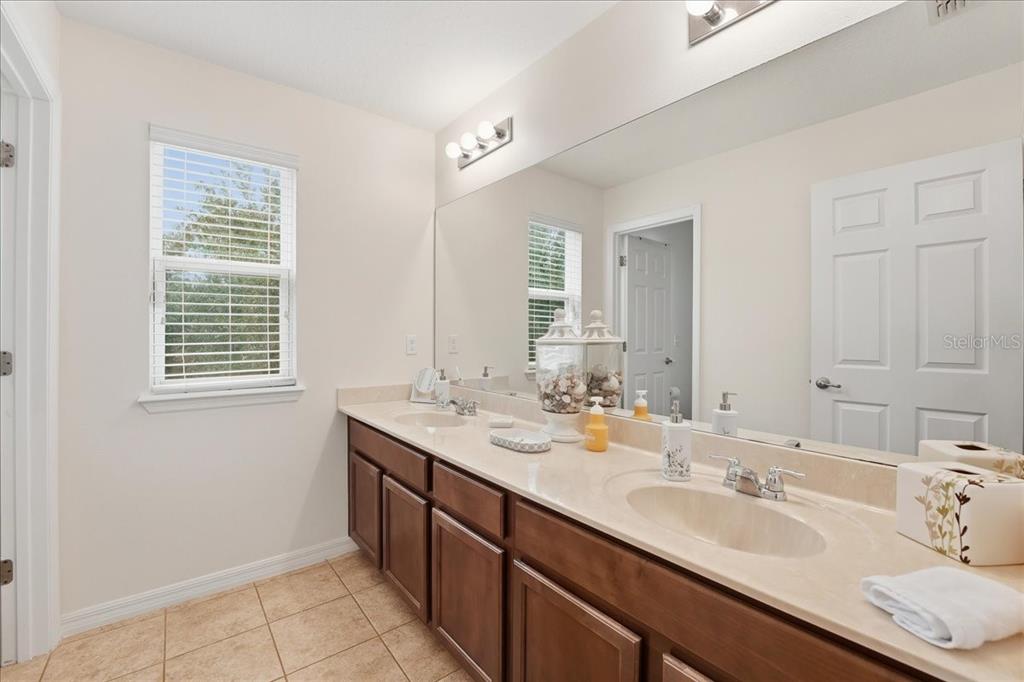 11675 Snail Kite Way Windermere, FL 34786 - Photo 37 of 46 a bathroom with double vanity sinks and a mirror