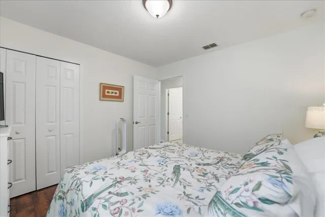 a view of a swimming pool with lawn chairs under an umbrella
