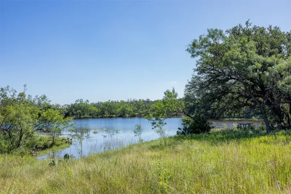a view of lake with green space