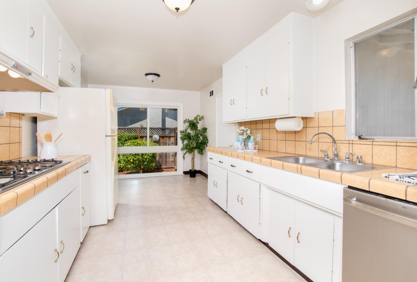 754 Ridge Rd. Santa Clara, CA 95051 - Photo 12 of 25 a kitchen with granite countertop a sink and a stove top oven