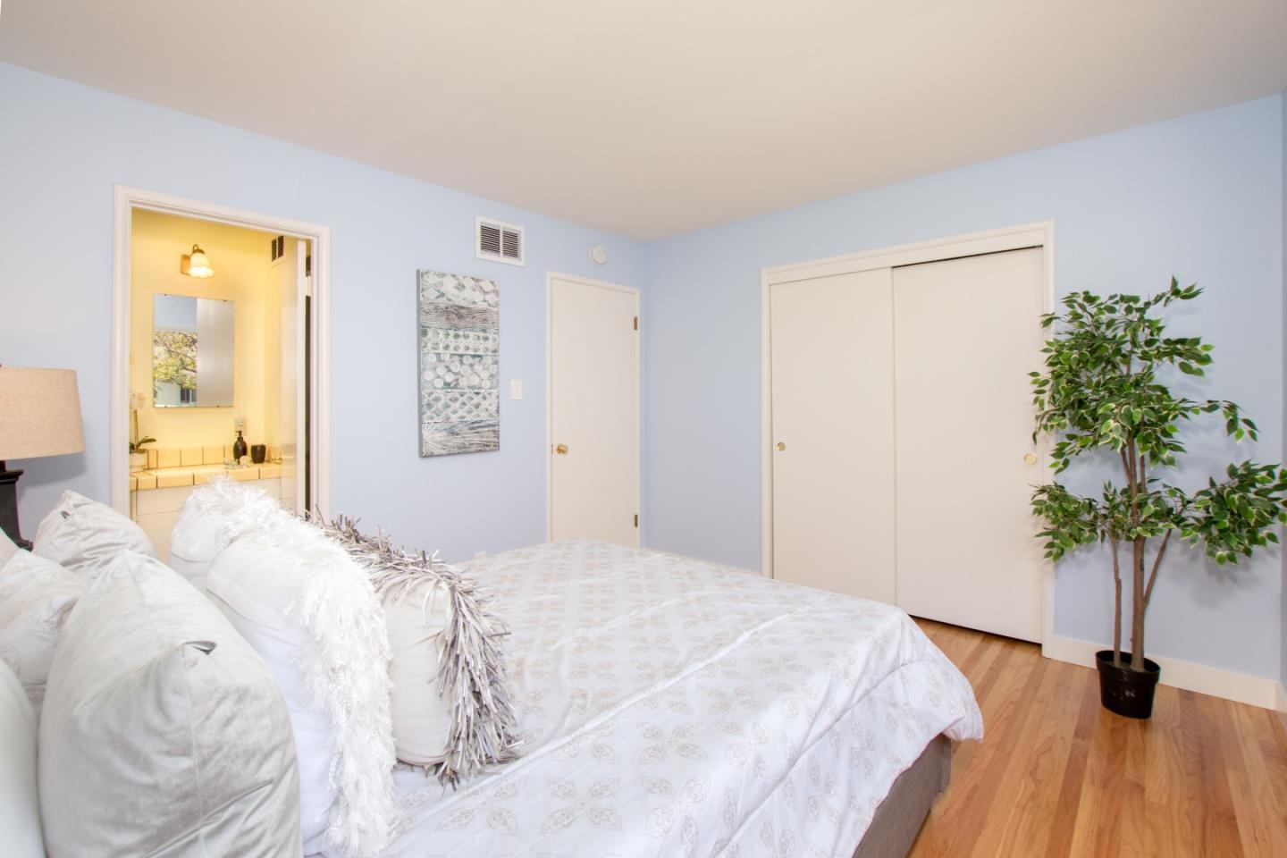 754 Ridge Rd. Santa Clara, CA 95051 - Photo 16 of 25 a bedroom with a bed and a potted plant