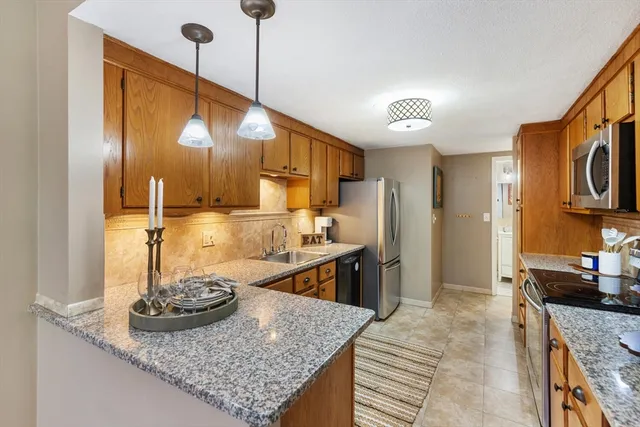 a kitchen with refrigerator and stove