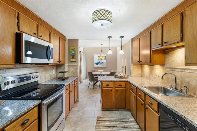 a kitchen with a sink stove and microwave