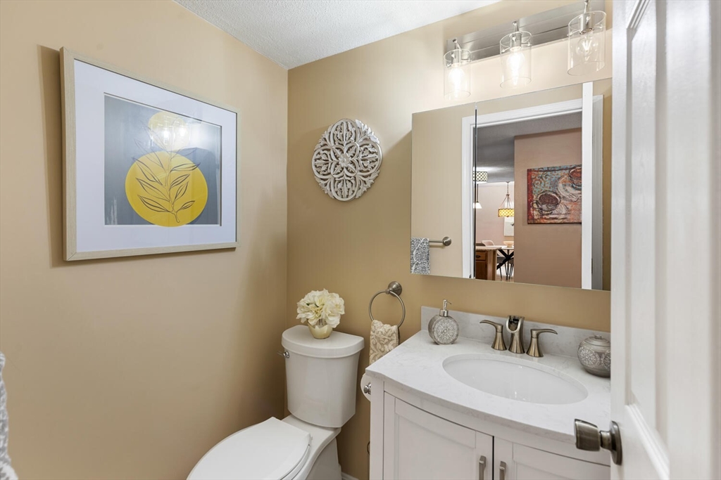 1100 Salem Street, Unit 58 Peabody, MA 01960 - Photo 17 of 36 a bathroom with a toilet sink and mirror