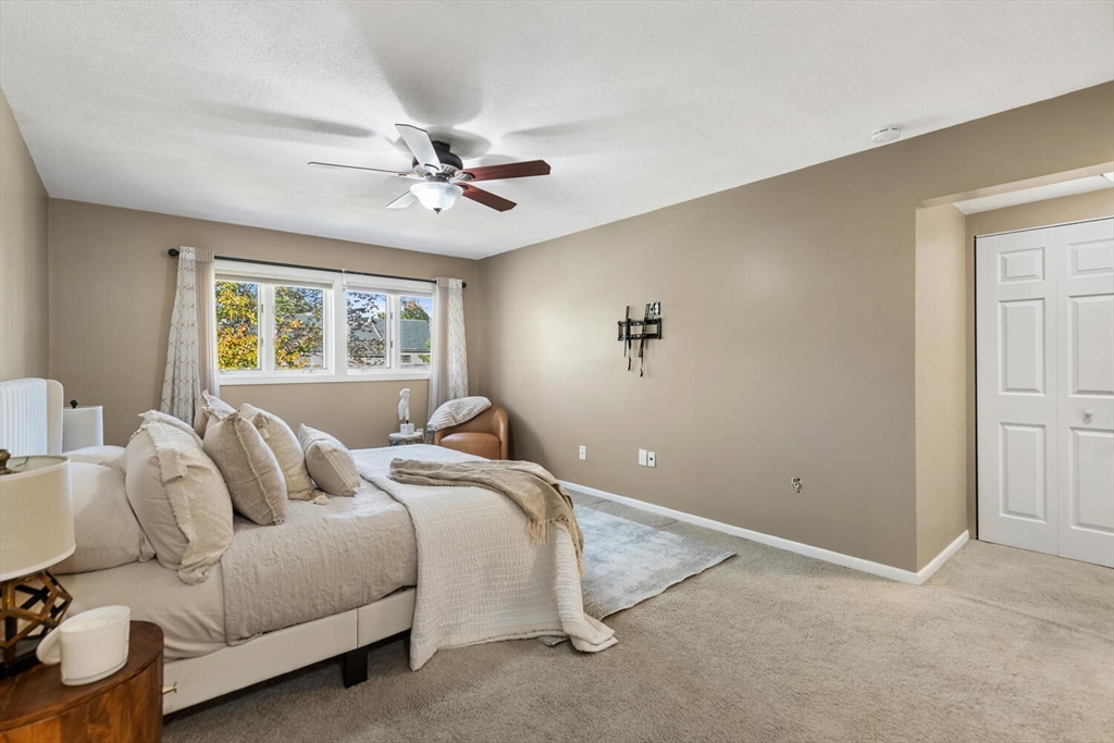 1100 Salem Street, Unit 58 Peabody, MA 01960 - Photo 19 of 36 a bedroom with a bed and a chandelier