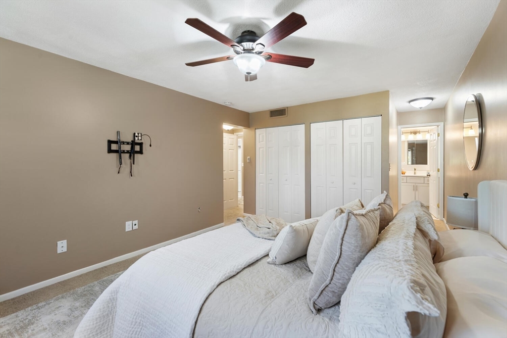 1100 Salem Street, Unit 58 Peabody, MA 01960 - Photo 20 of 36 a bedroom with a large bed and a chandelier