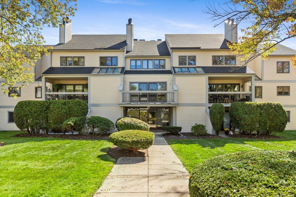 1100 Salem Street, Unit 58 Peabody, MA 01960 - Photo 2 of 36 a front view of a house with a yard