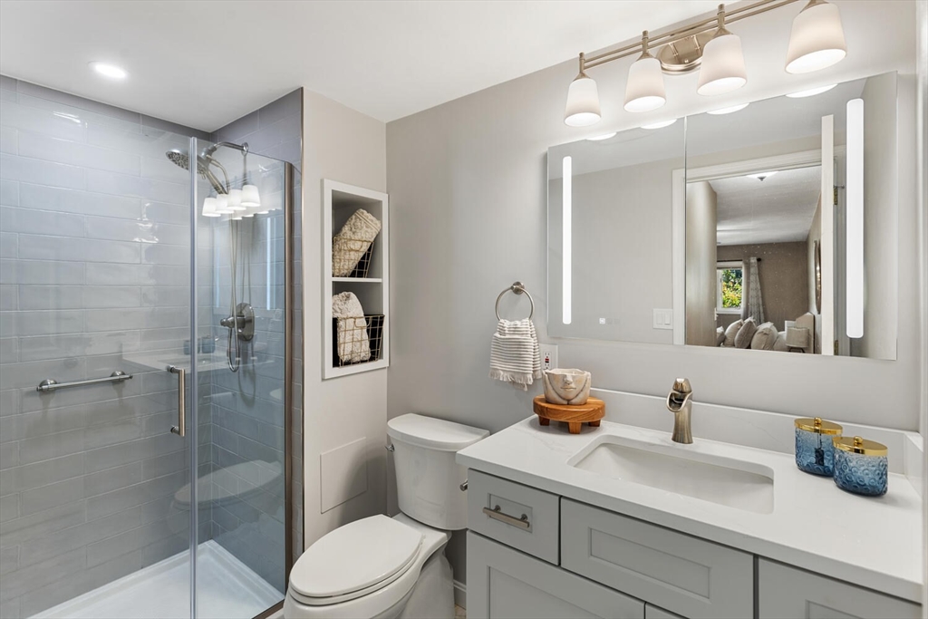 1100 Salem Street, Unit 58 Peabody, MA 01960 - Photo 21 of 36 a bathroom with a sink vanity granite toilet and shower