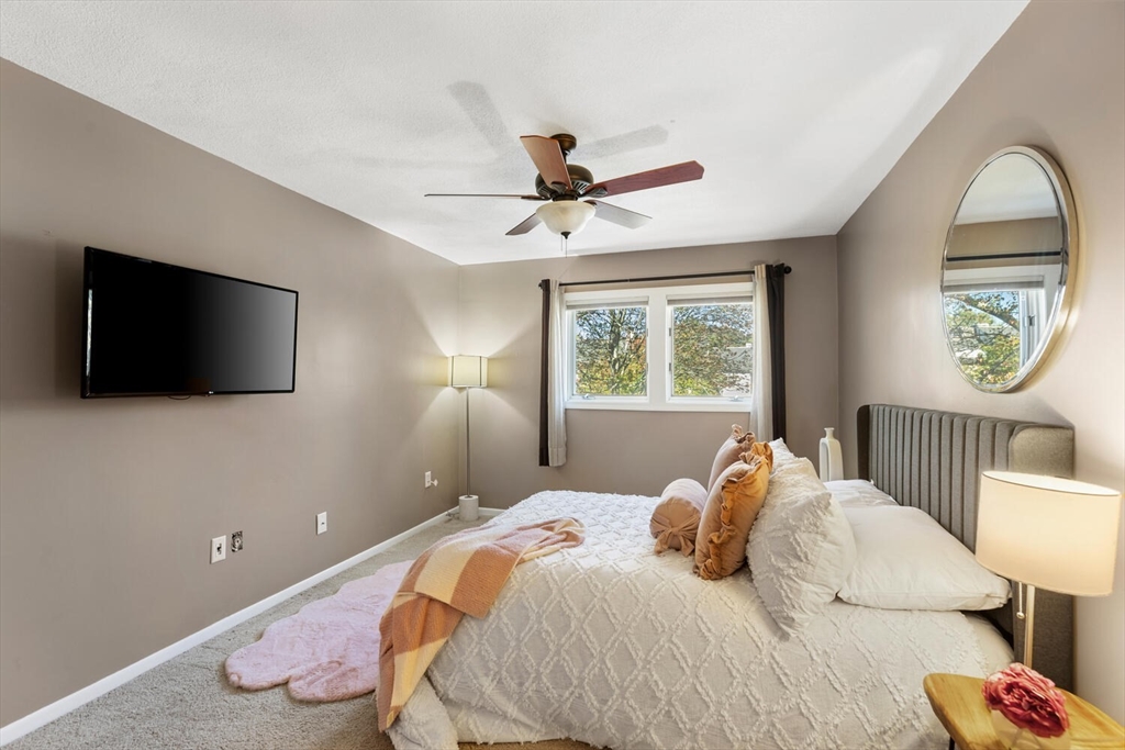1100 Salem Street, Unit 58 Peabody, MA 01960 - Photo 22 of 36 a bedroom with a bed and a flat screen tv