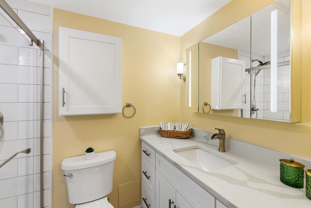 1100 Salem Street, Unit 58 Peabody, MA 01960 - Photo 23 of 36 a bathroom with a granite countertop sink and a mirror