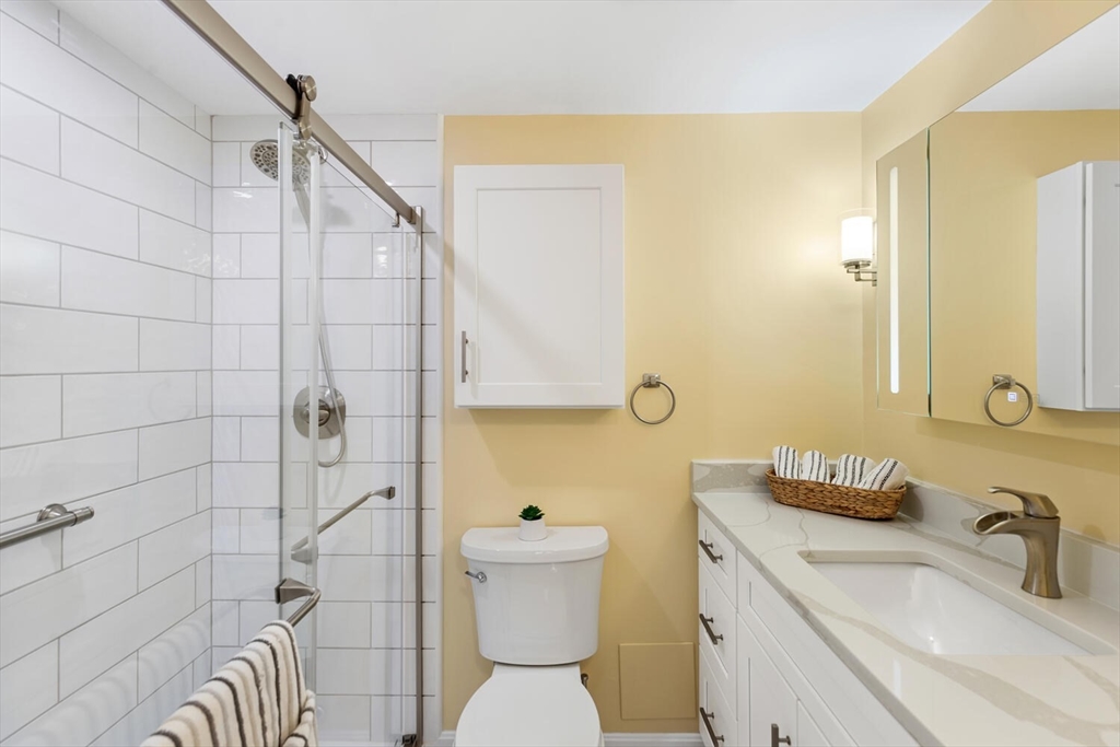 1100 Salem Street, Unit 58 Peabody, MA 01960 - Photo 24 of 36 a bathroom with a sink a toilet and shower