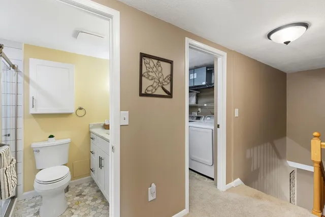 a bathroom with a toilet sink and shower