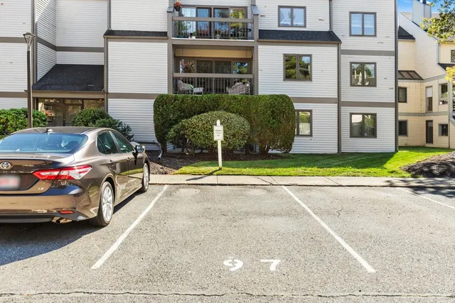 a view of a cars park in front of a building