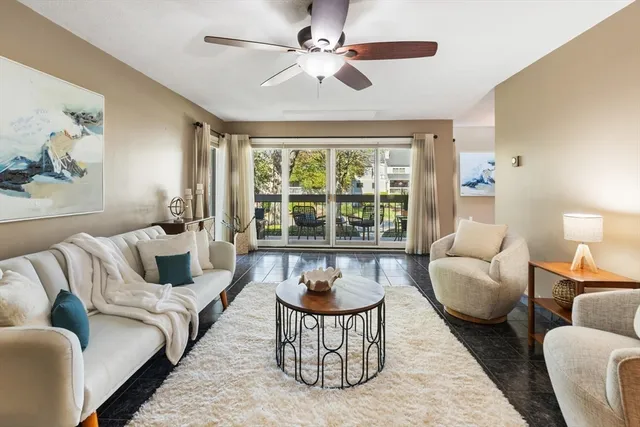 a living room with furniture and a large window