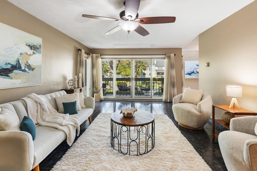 1100 Salem Street, Unit 58 Peabody, MA 01960 - Photo 4 of 36 a living room with furniture and a large window
