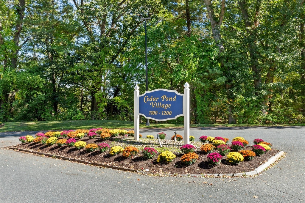 1100 Salem Street, Unit 58 Peabody, MA 01960 - Photo 5 of 36 a sign that is sitting in front of flowers
