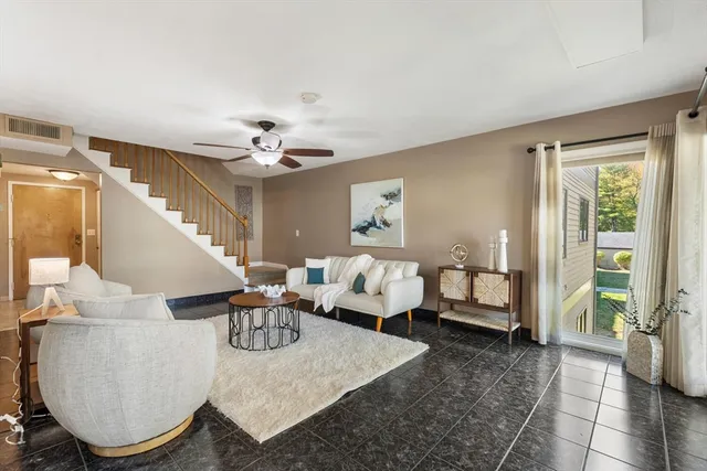 a living room with furniture and a chandelier