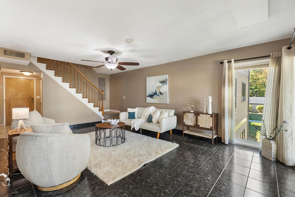 1100 Salem Street, Unit 58 Peabody, MA 01960 - Photo 8 of 36 a living room with furniture and a chandelier