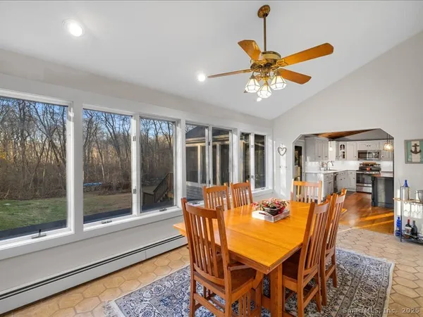 a dining room with furniture a chandelier and window